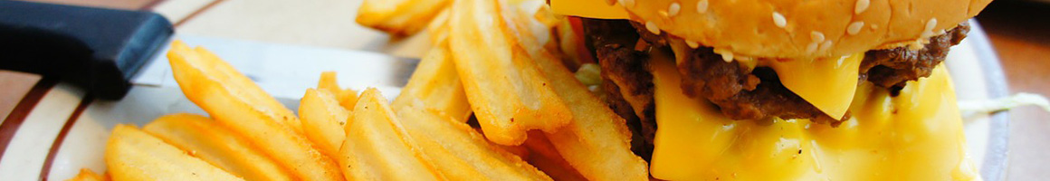 Eating American (Traditional) Burger at George's Drive Inn restaurant in Walsenburg, CO.